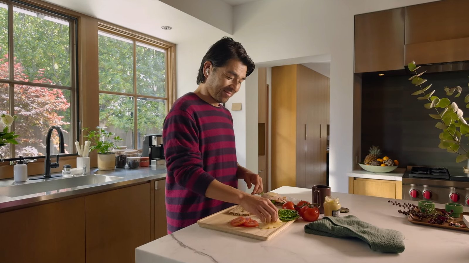Hands-Free Siri Control with AirPods: Using Head Gestures in the Kitchen Person using AirPods to control Siri with head gestures while preparing food in the kitchen